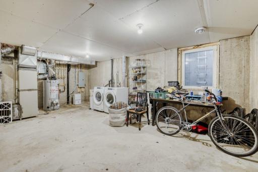 The lower level boasts newer washer and dryer, an egress window, and (out of frame) the builder planned for an additional bathroom to be added to this level. There is so much space for storage and the possibility of adding finished square footage to