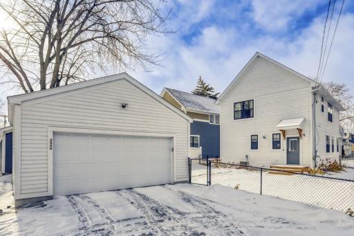 2 car garage with a large driveway and fully fenced in yard.