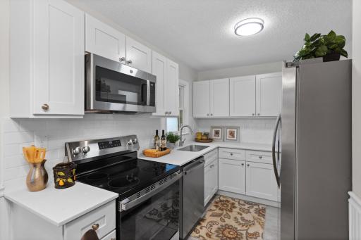 Kitchen with new counter tops, cabinets and stainless steel appliances