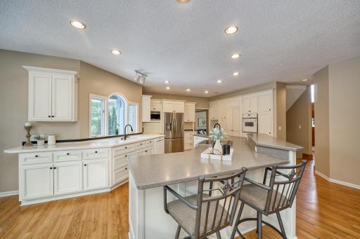 Large, open, sun-drenched kitchen with expansive counters and ample storage