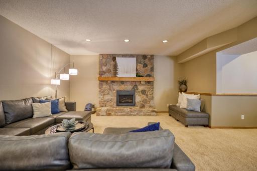 Spacious Walk-Out Level Amusement Room, a Beautiful Stone Fireplace, a Wet Bar, Billiards space, walks out to a Cobble Stone Patio, and the new Hot Tub.