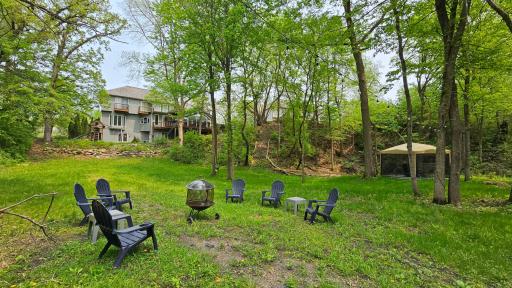 Spring Views of the Fire Pit Area, the Stone Landscaping, and the woods.