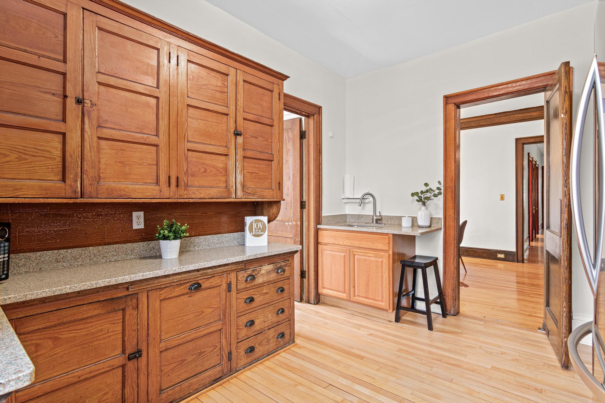 Original cabinetry, Stone Countertops, and recently restored hardwood floors.