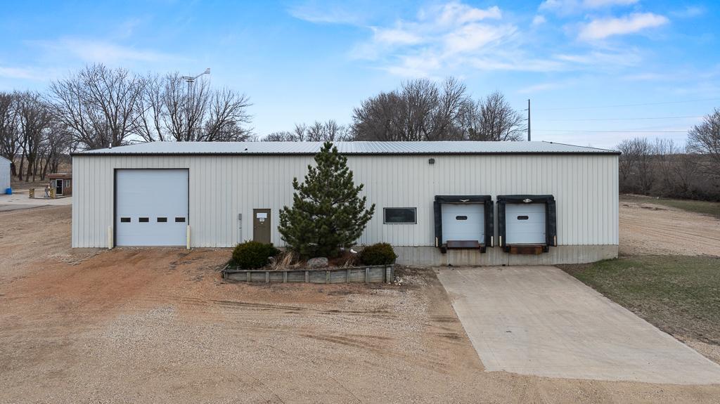 East side of the warehouse - 2 semi loading docks with concrete parking area and 14'W x 15'H overhead garage doors
