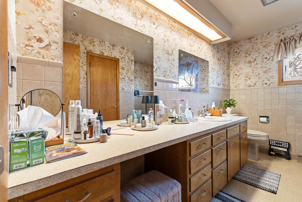 A full bathroom with a large vanity offers a spacious area to get ready for the day