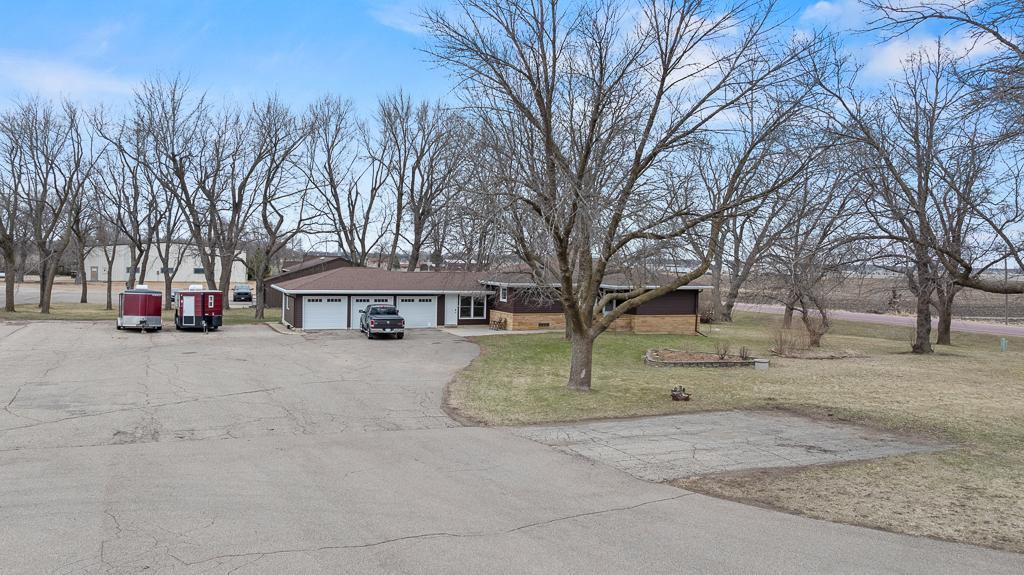 Asphalt driveways on both the north and south side of the property offering easy access to the home and office site.