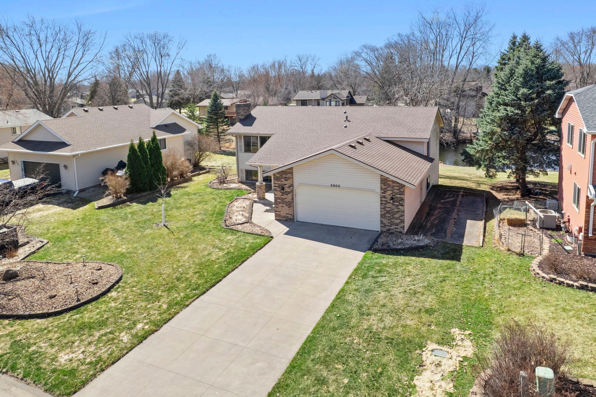 Expansive concrete driveway, ready to withstand those Minnesota winters and summer heat while continuing to invite you home