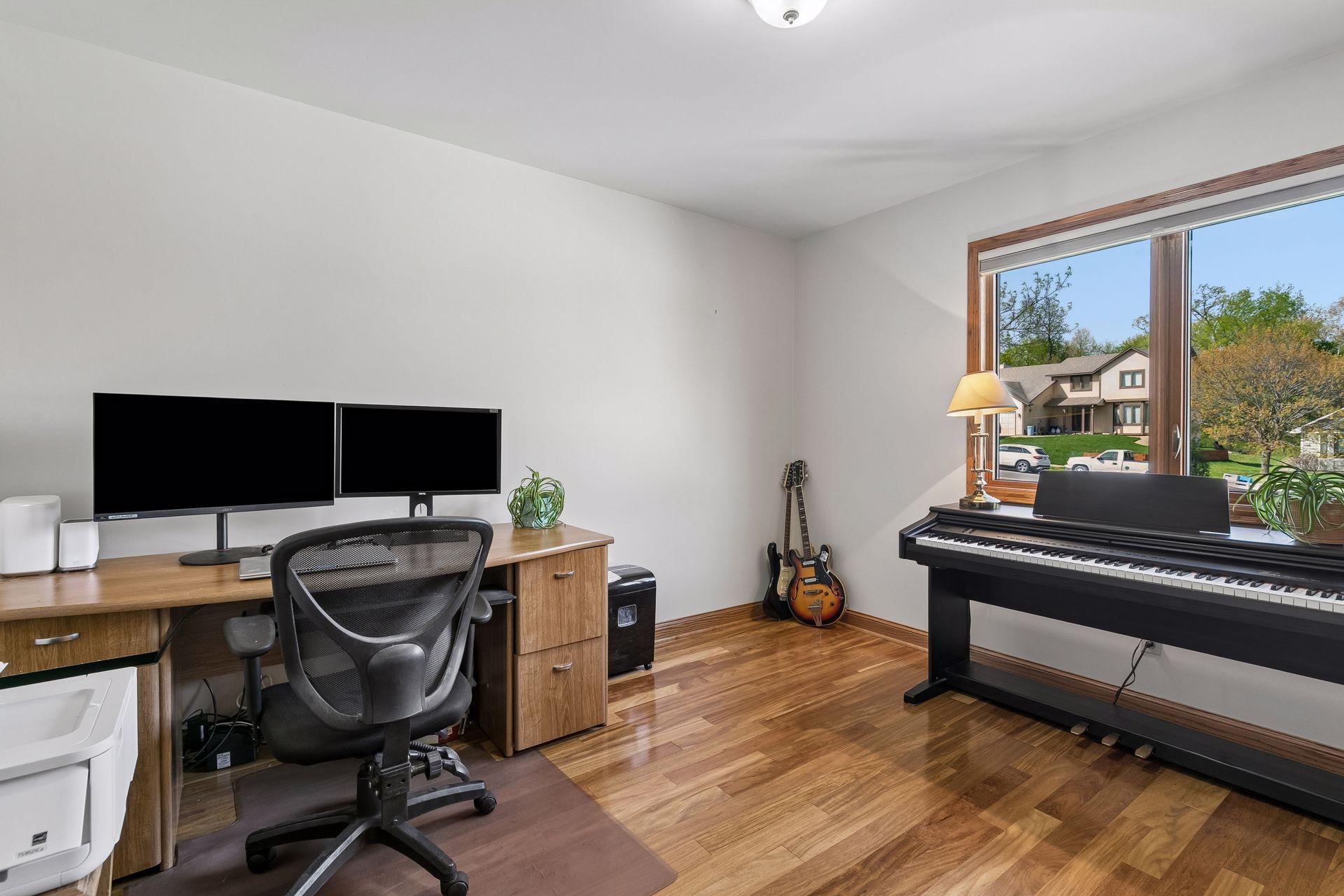 Spacious upper-level 3rd bedroom with great natural light, warm wood finishes, and comfortable layout perfect for bedroom, guest room, nursery, or home office.