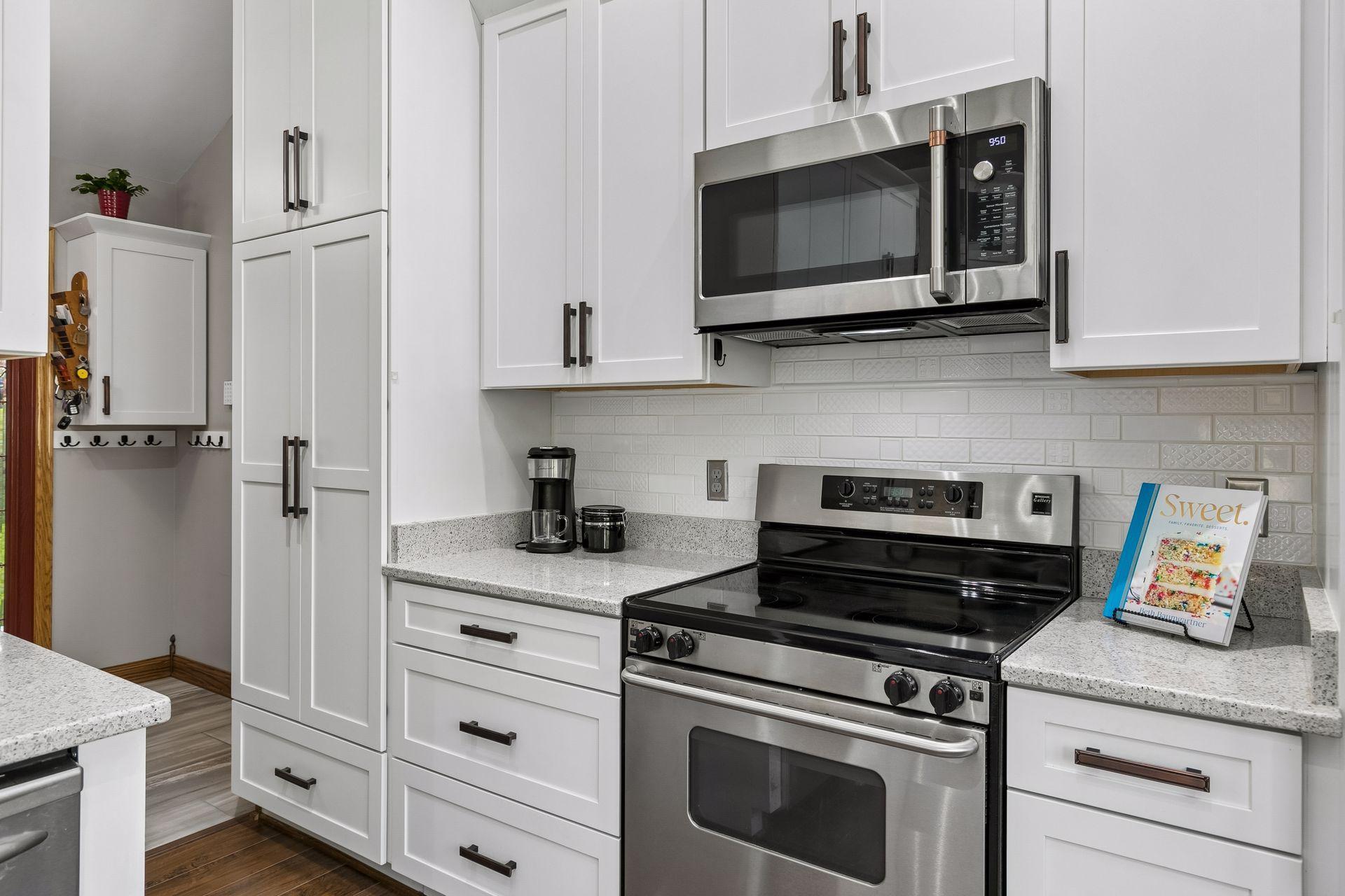 Bright and functional kitchen with modern finishes, pantry storage, recessed lighting and excellent workspace for cooking, entertaining, and family gatherings.