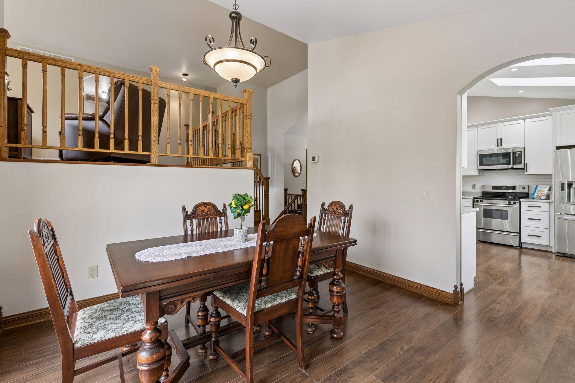 Elegant formal dining room with vaulted ceilings, open-concept design, and natural wood accents, perfect for holiday gatherings, entertaining guests and everyday dining.