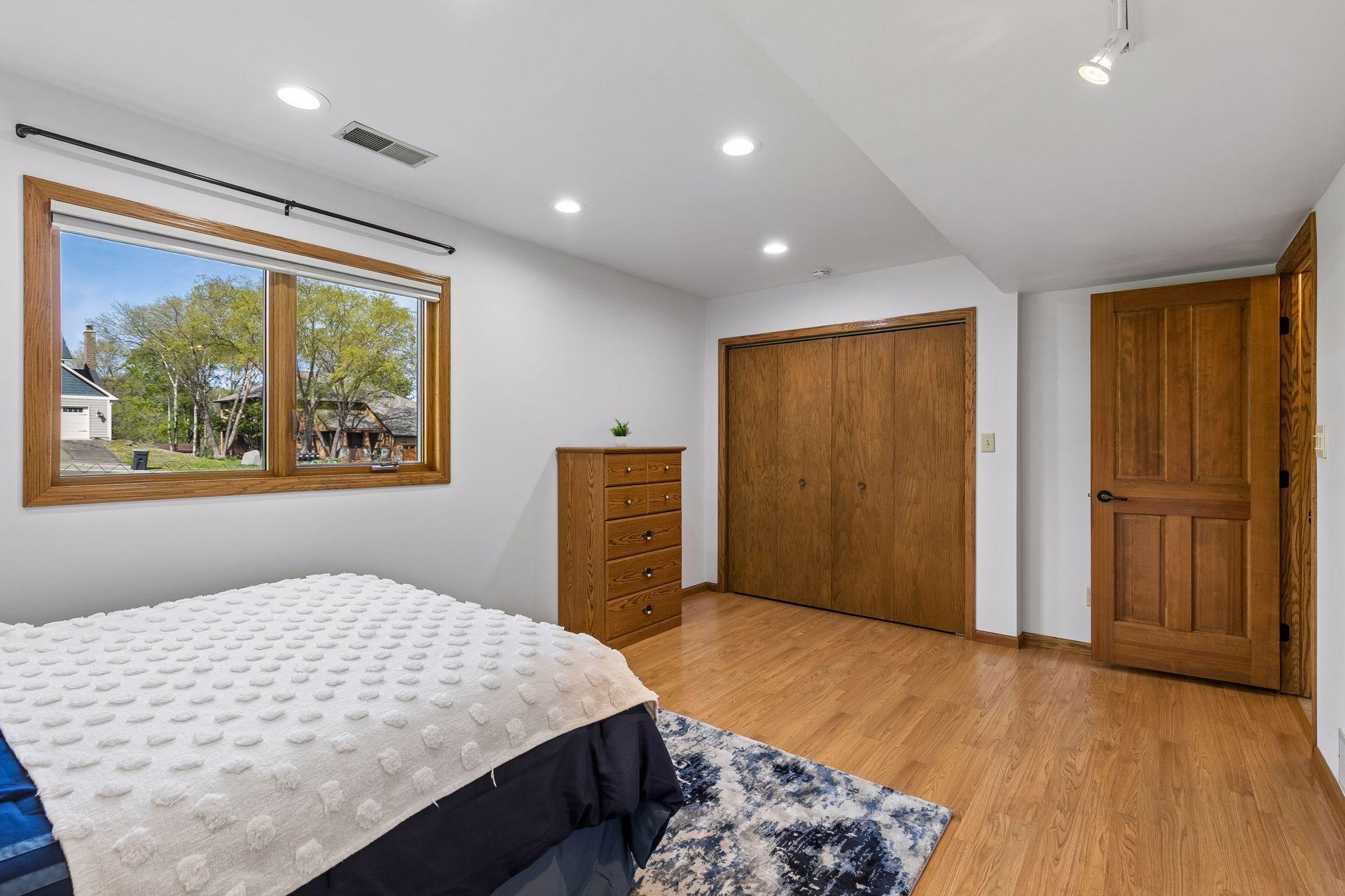 Spacious lower-level 5th bedroom with large closet, recessed lighting and updated flooring. Great setup for guests, multigenerational living or a private home office.