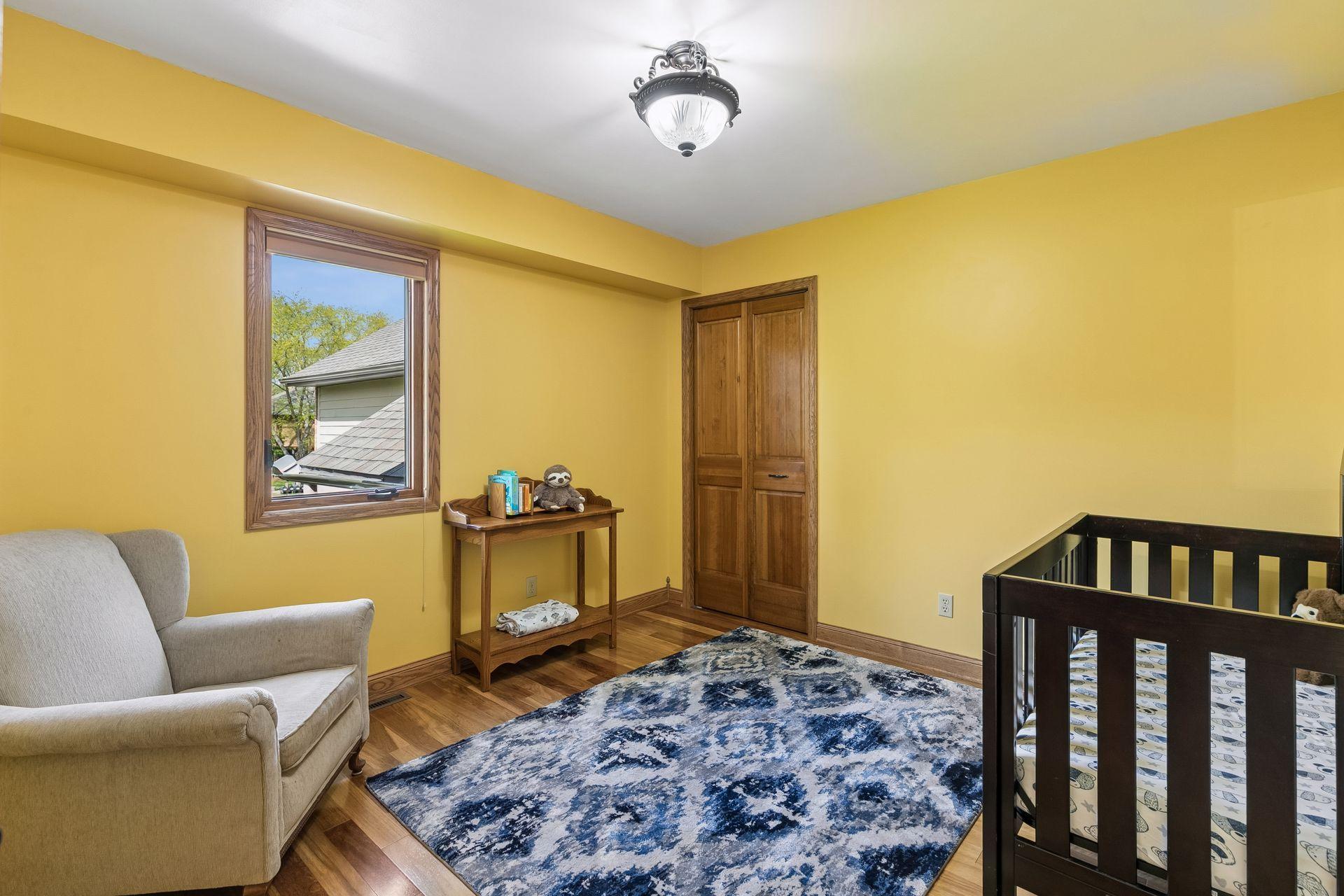 Bright upper-leve 2ndl bedroom with hardwood-style flooring, large closet and flexible layout perfect for guest bedroom, nursery, or kids’ room.