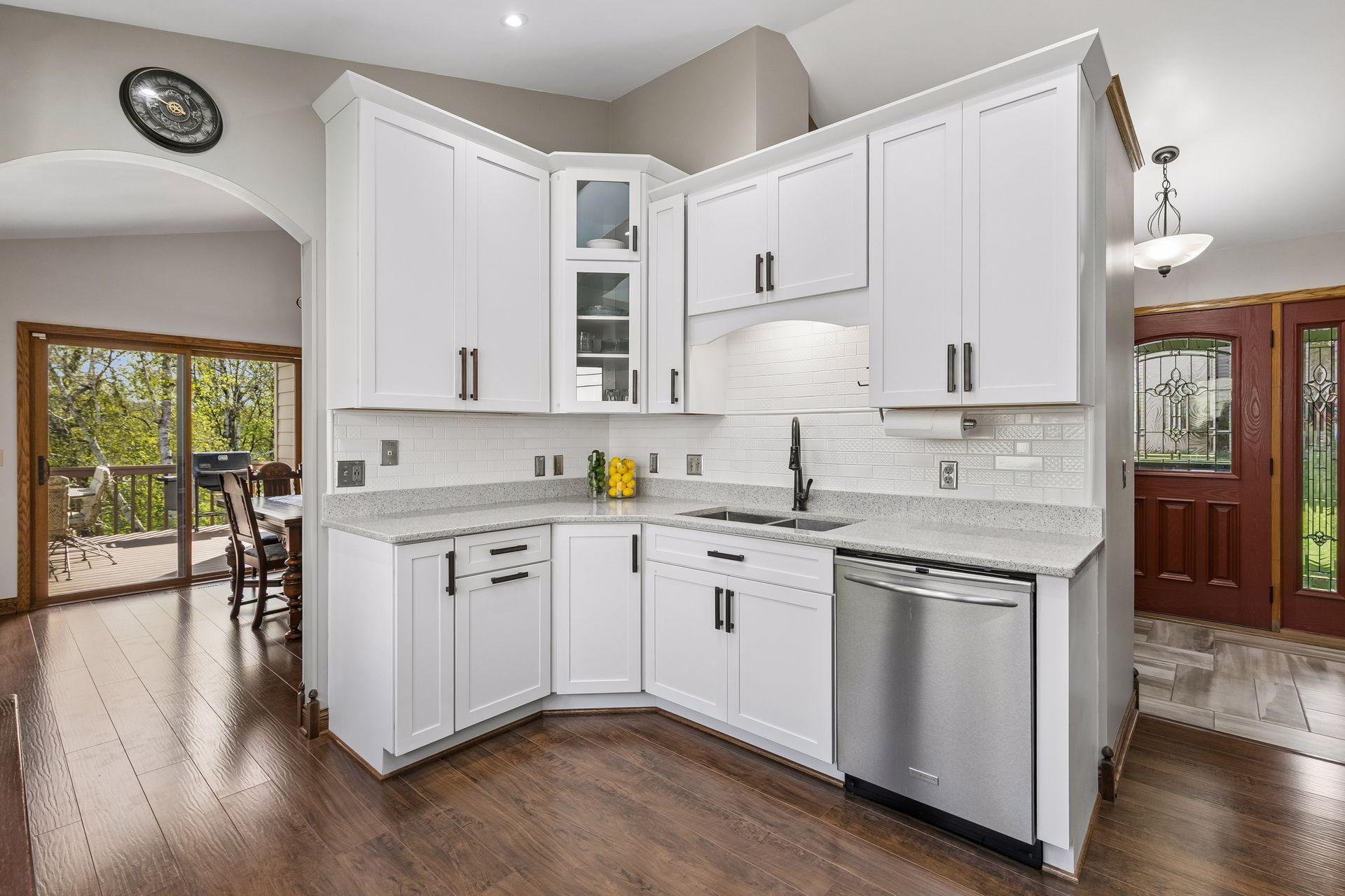 Stylish kitchen with updated cabinetry, soft-close cabinets, farmhouse sink, modern hardware, and open flow to dining and outdoor living areas, ideal for today’s lifestyle and entertaining needs.