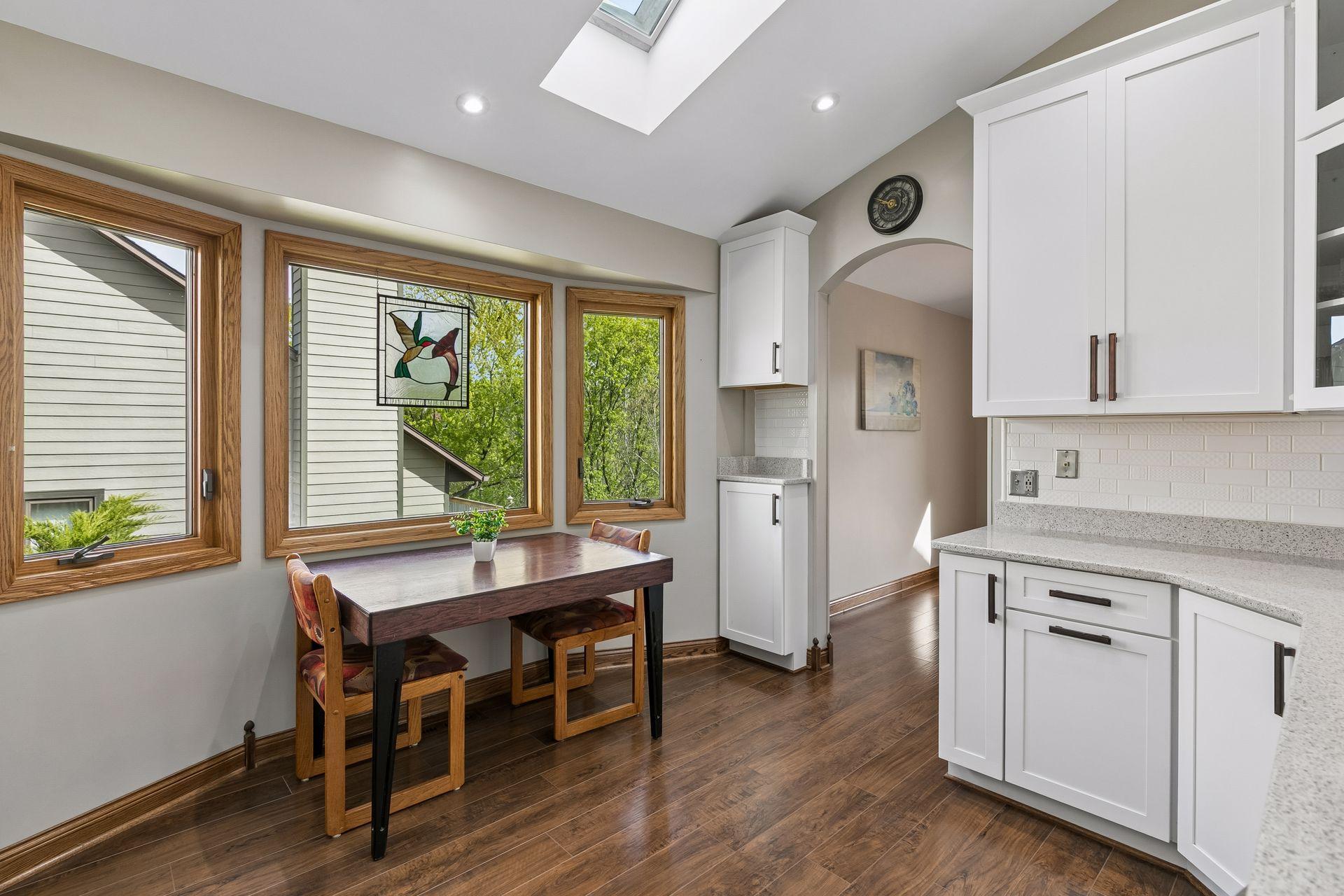 Sun-filled eat-in kitchen space with scenic views and warm natural wood accents, perfect for morning coffee, homework time or casual family meals.