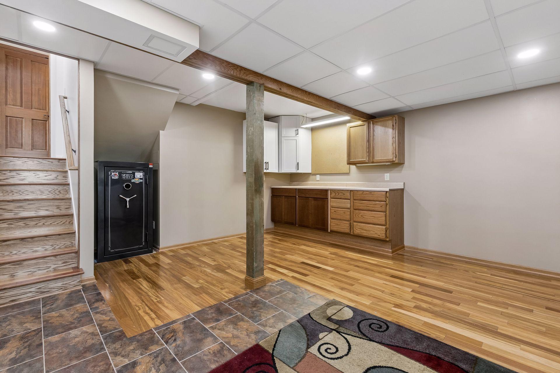 Another view of the lower-level laundry and storage area featuring built-in cabinetry, countertop workspace and flexible bonus space for organization or projects.