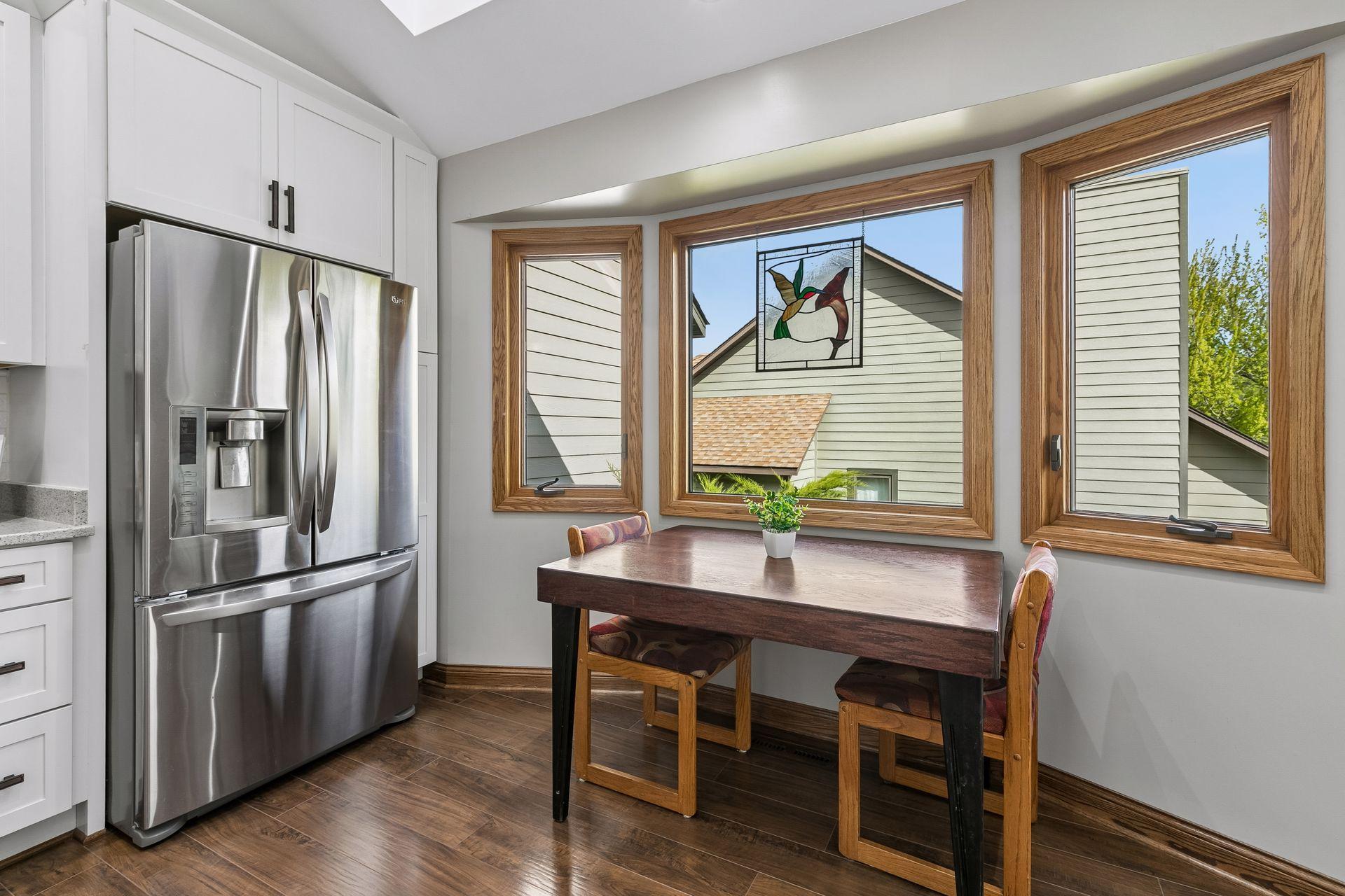 Bright informal dining area with a charming bay window, skylight, and abundant natural light, creating a warm and inviting space for everyday meals and morning coffee.