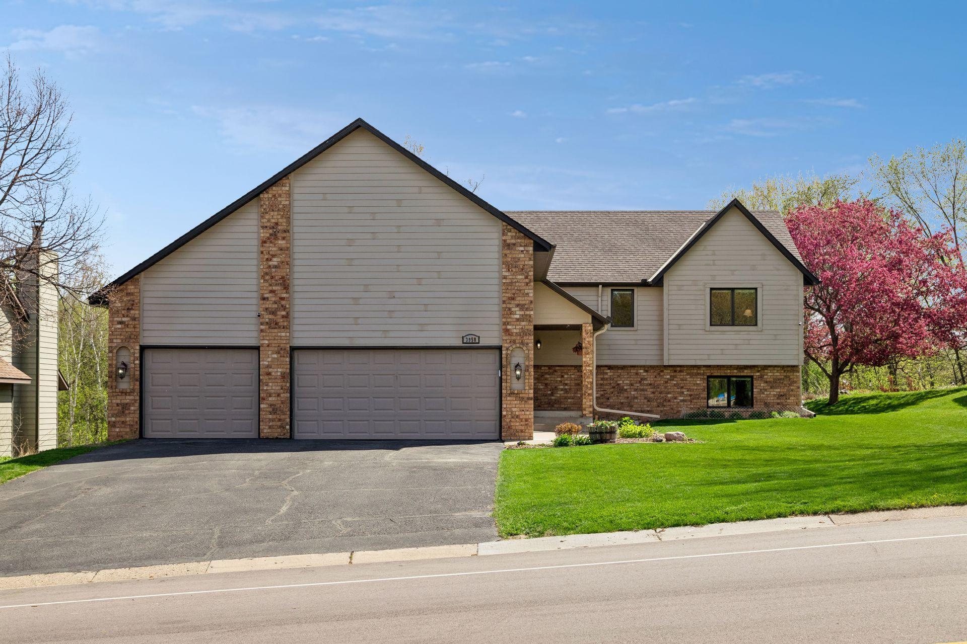 Impressive curb appeal with a spacious driveway, maintenance-friendly landscaping and a peaceful wooded setting offering space, privacy and beautiful natural surroundings.