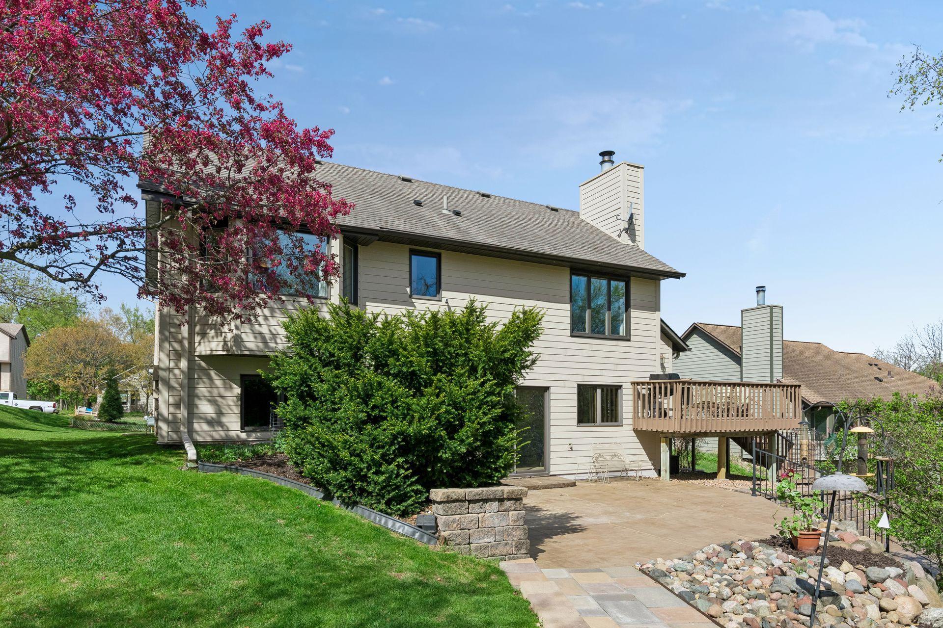 Private backyard retreat with spacious patio, mature trees, and peaceful wooded views creating a perfect setting for relaxing or entertaining outdoors.