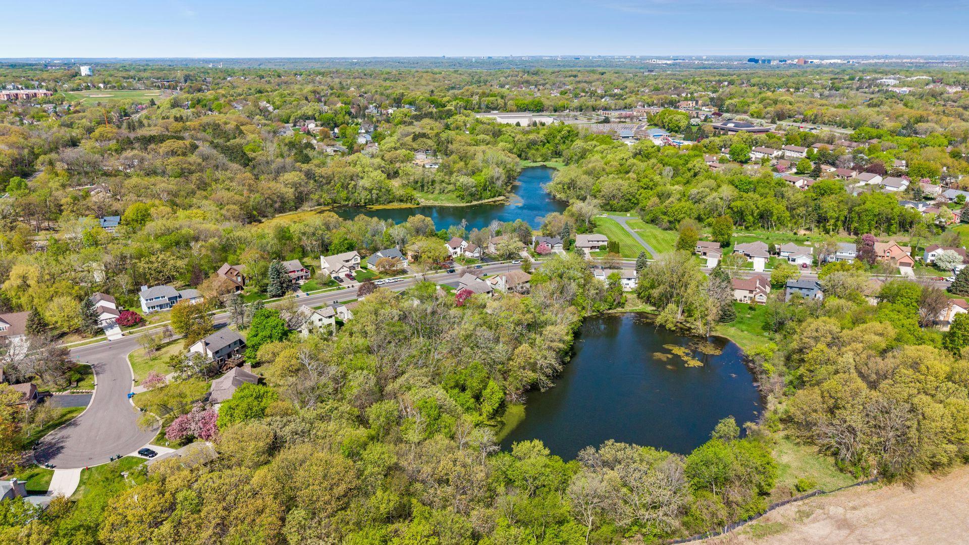 Stunning aerial views of nearby ponds, Lebanon Hills Regional Park, scenic walking and biking trails, and beautiful wooded surroundings highlighting this highly desirable Eagan location close to nature, shopping, dining and everyday conveniences.