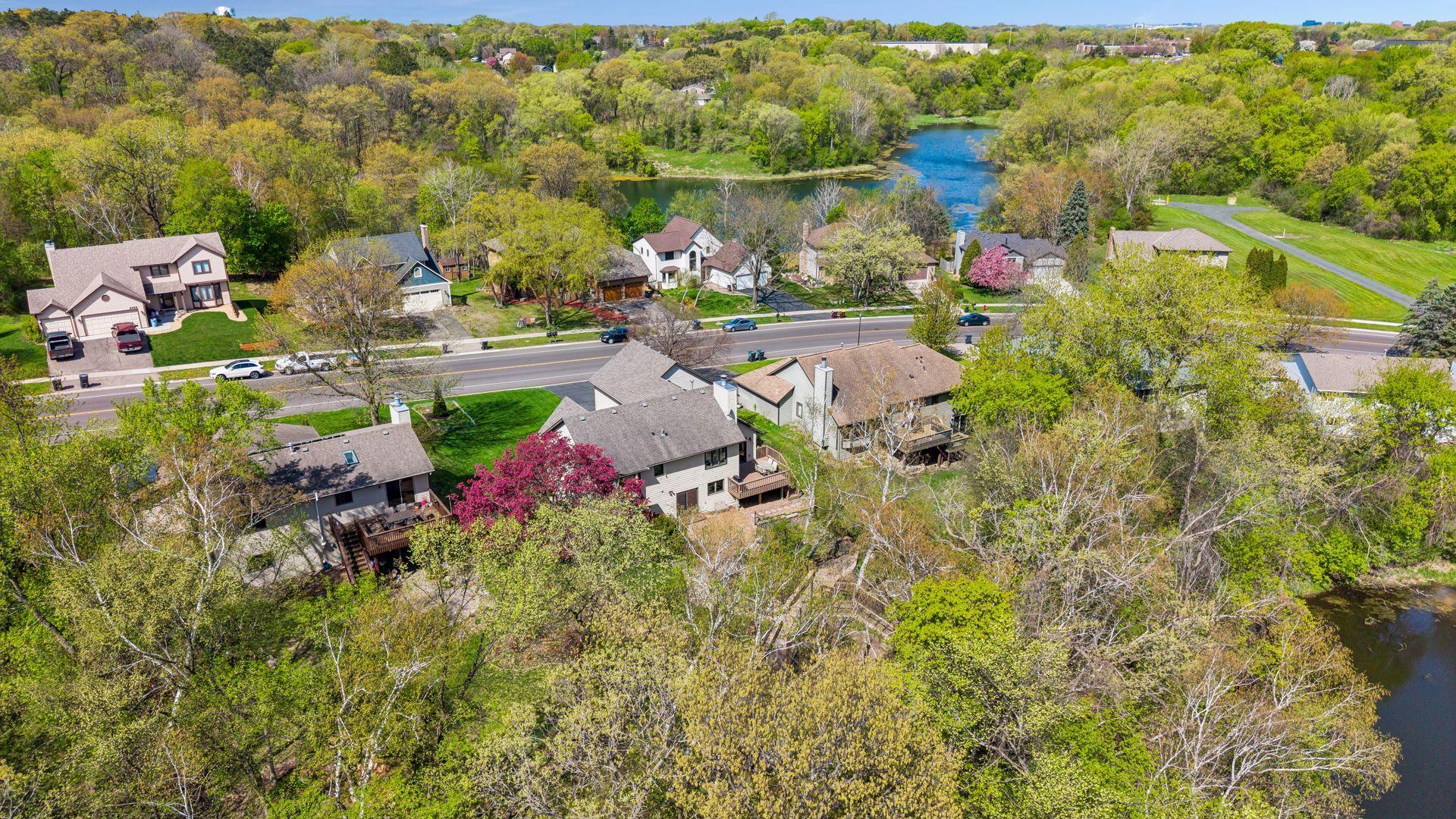Aerial view showcasing this private wooded setting near ponds, trails, and parks in a highly desirable Eagan location within award-winning School District 196.