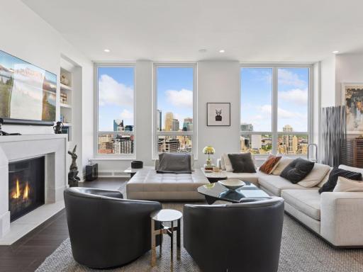 Spacious living area with floor-to-ceiling windows and stunning skyline views.