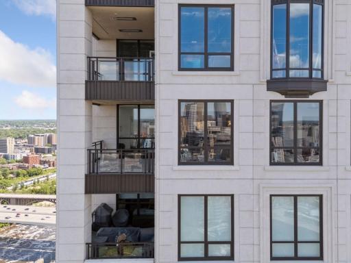 Expansive windows showcase skyline and riverfront vistas.