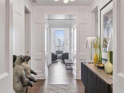 Stylish foyer with custom paneling and modern lighting.