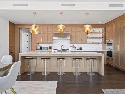 Chef’s kitchen with oversized island, high-end appliances, and custom cabinetry.