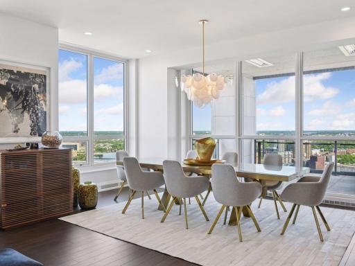 Dining room with floor-to-ceiling windows and skyline views.