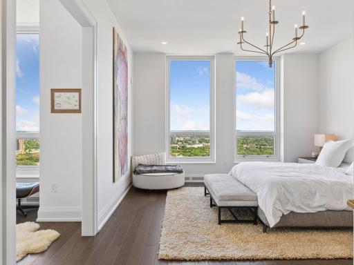 Primary suite with expansive windows and natural light.