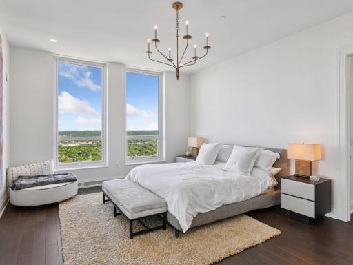 Spacious primary suite with large windows showcasing panoramic views.