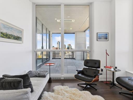 Cozy sitting area off the primary suite with city skyline views.