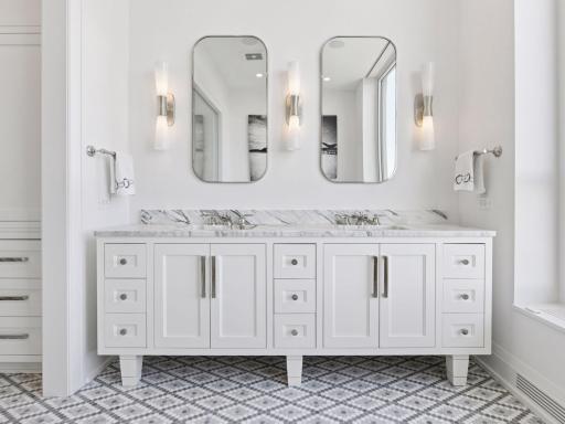 Dual vanity with marble counters and elegant fixtures.