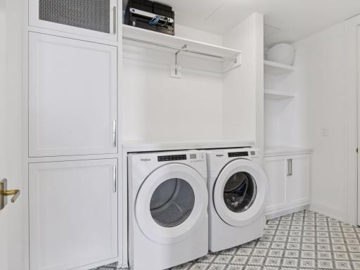 Well-appointed laundry room with built-ins and modern appliances.
