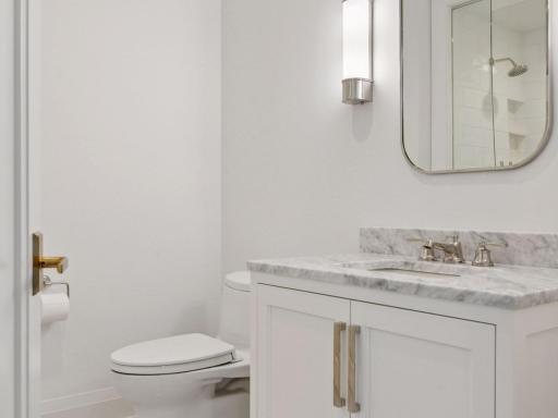 Stylish vanity with marble countertop and modern lighting.
