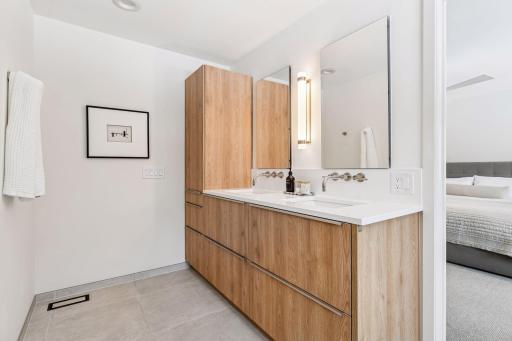 Abundant storage with floor-to-ceiling cabinetry and pristine quartz countertops elevates everyday routines to five-star experiences.