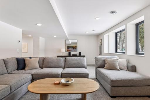Expansive walkout lower level with bright windows and neutral designer palette. This finished lower level family room is perfect for media, games, or additional living space.