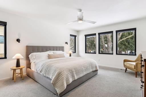 The expansive and luxurious main-floor primary suite is a haven for rest and relaxation.
