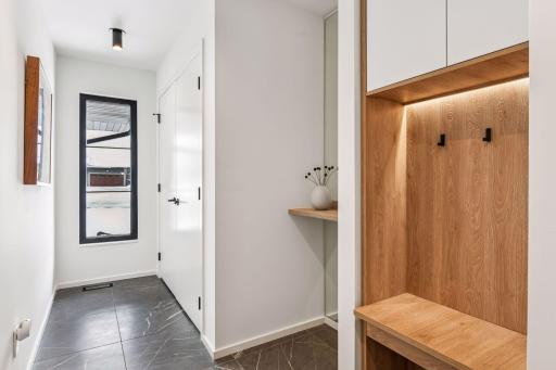 Premium designer tile flooring and thoughtful storage solutions make this functional space both beautiful and practical for everyday living.