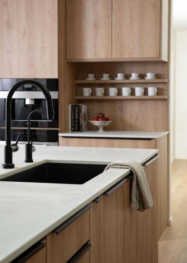 Matte black fixtures and hardware provide sophisticated contrast against warm oak.