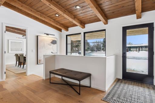 Impressive front entry with sleek black-framed door and designer exterior lighting sets the tone for the luxury that awaits inside this completely renovated Parkwood Knolls estate.