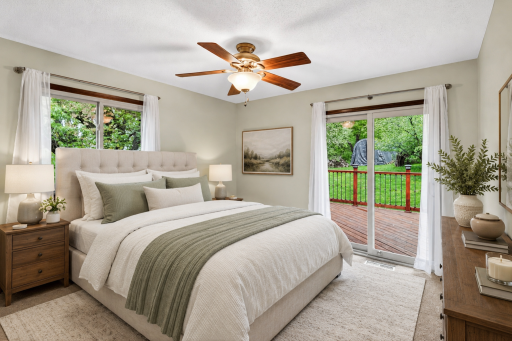 Primary bedroom with deck access *This room has been virtually staged*