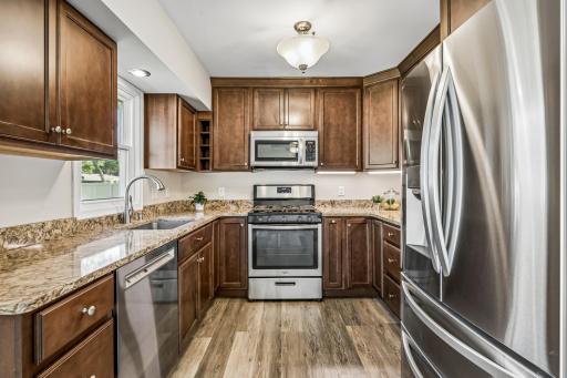 Remodeled kitchen features Cambria counters, an abundance of high-end cabinets with lots of bells & whistles (lazy Susans, soft close drawers/doors, pull-out spice storage, wine niche, pull-out garbage & recycling bins, & more)!