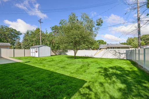 Vinyl privacy fence installed in 2024 with two handy gates to front and side yard!