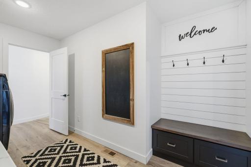 Laundry room with custom built ins, drying racks, and storage!