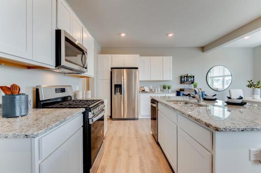 Ample storage in this gorgeous kitchen. This newly finished home includes hardware and backsplash. Actual photos coming soon. (Photos of the same floorplan, colors are similar).