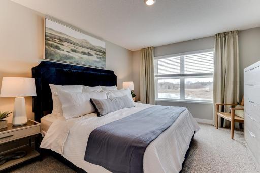 The home's second level starts with this oasis of a primary suite!! (Photos of the same floorplan, colors are similar).