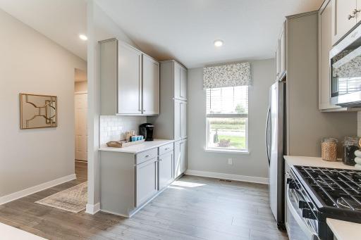 Check out the amazing gas range and subway tile backsplash. Large kitchen window provides additional natural light.