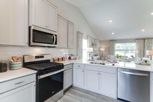 An abundance of cabinet and countertop prep space make this kitchen layout functional and desirable.
