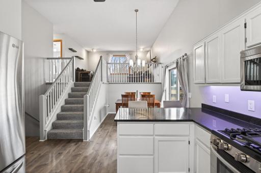 Granite countertop, freshly refinished white cabinets and stainless steel appliances